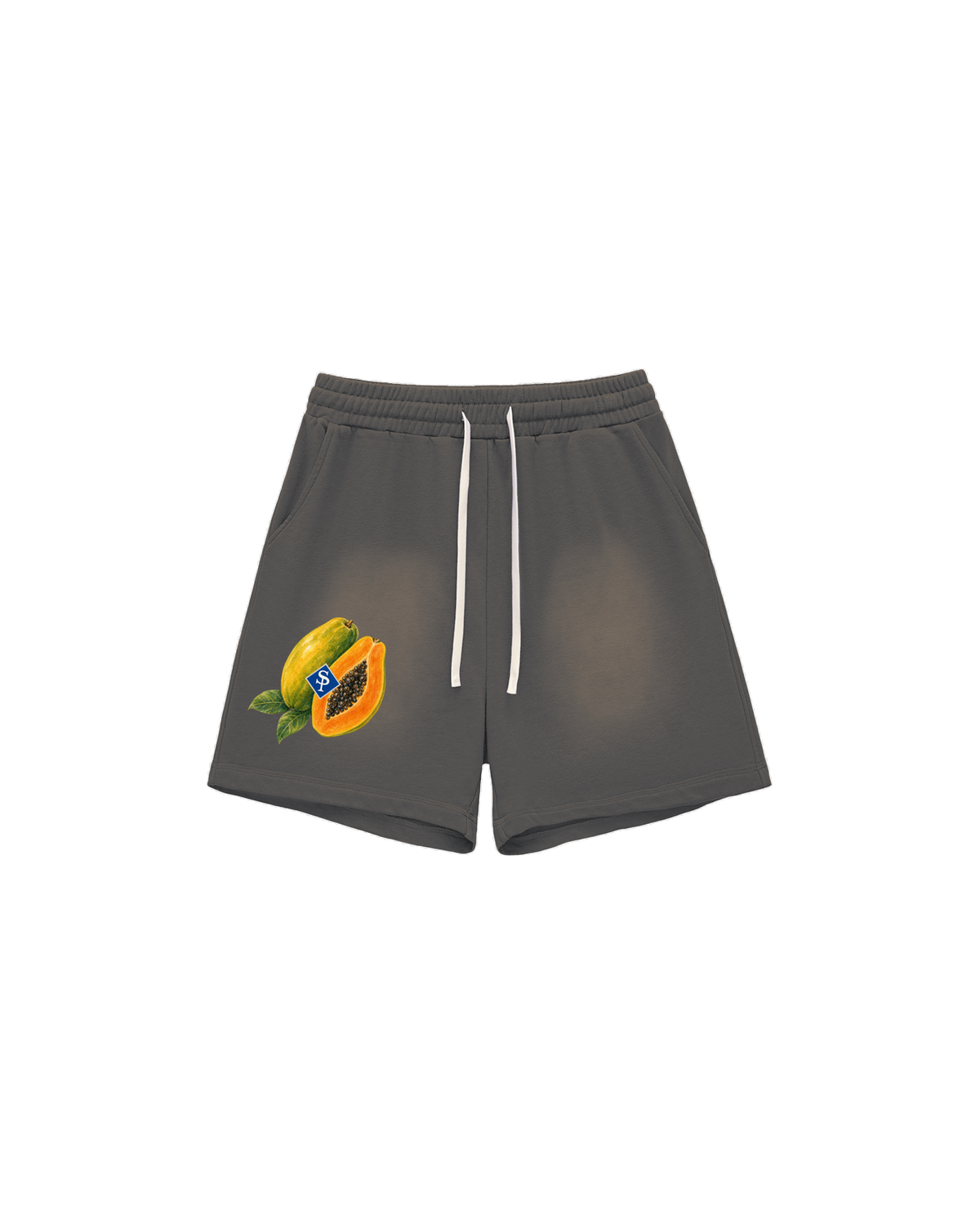 Sun-faded grey shorts with white drawstring; a whole and cut papaya with black seeds sits low on the left thigh.