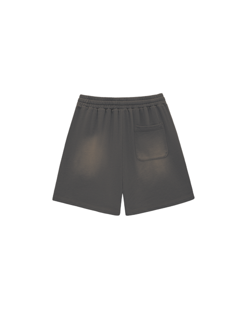 Back view of the same grey shorts: plain, uneven fade, elasticated waist, one patch pocket on the right hip.