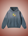 Front of the slate blue hoodie, washed pale at the shoulders: a whole guava and a halved one showing pink flesh, the blue SP diamond laid over them, small at the chest.