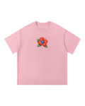 Boxy pink cotton tee with a small scarlet hibiscus at the chest, a blue SP diamond set into the bloom.